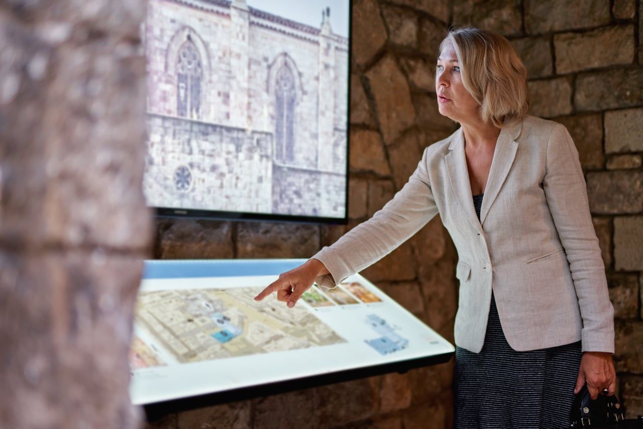 A visitor using an interactive display in a museum